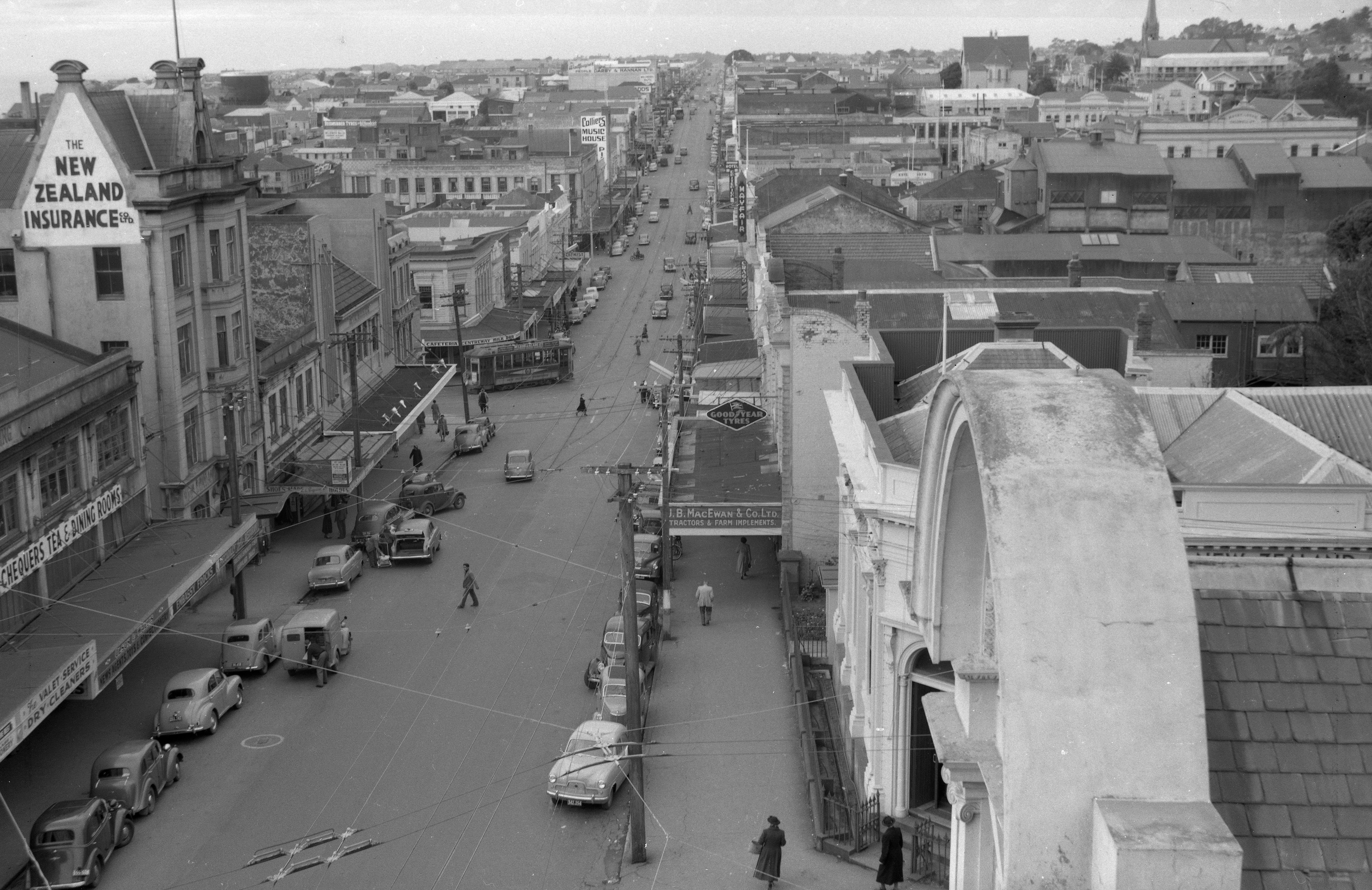 View of Devon Street from the clock tower (July 1954). Caleb Wyatt. Collection of Puke Ariki, New Plymouth (PHO2011-0031).