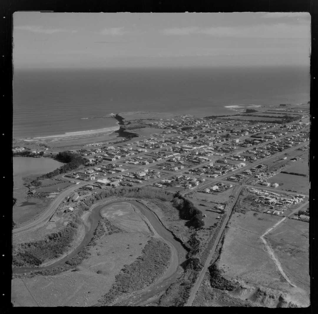 View of Opunake with the Waiaua River in the foreground (22 August 1958). Whites Aviation. Collection of the Alexander Turnbull Library (WA-47149-F).