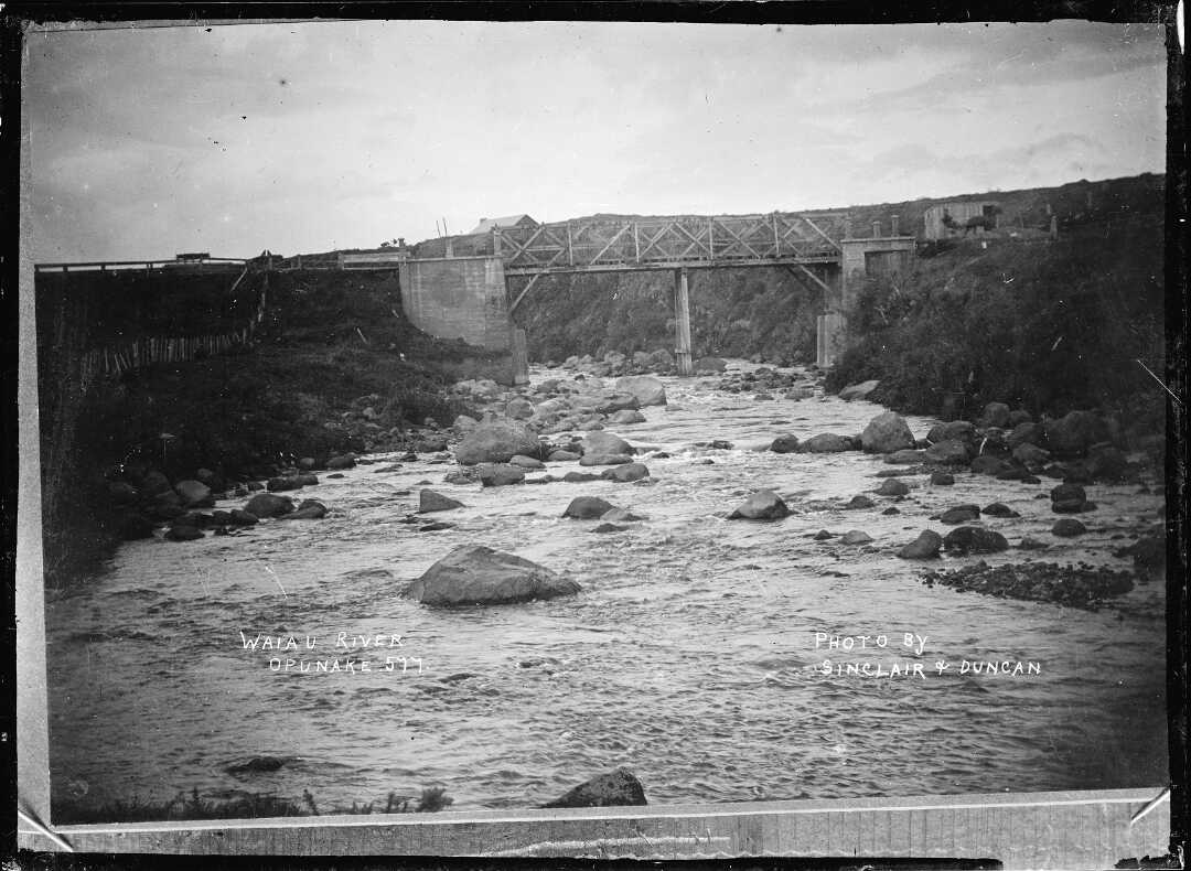 Bridge over the Waiaua River at Opunake (around 1910). Sinclair & Duncan. Collection of the Alexander Turnbull Library ( 1/2-001076-G).