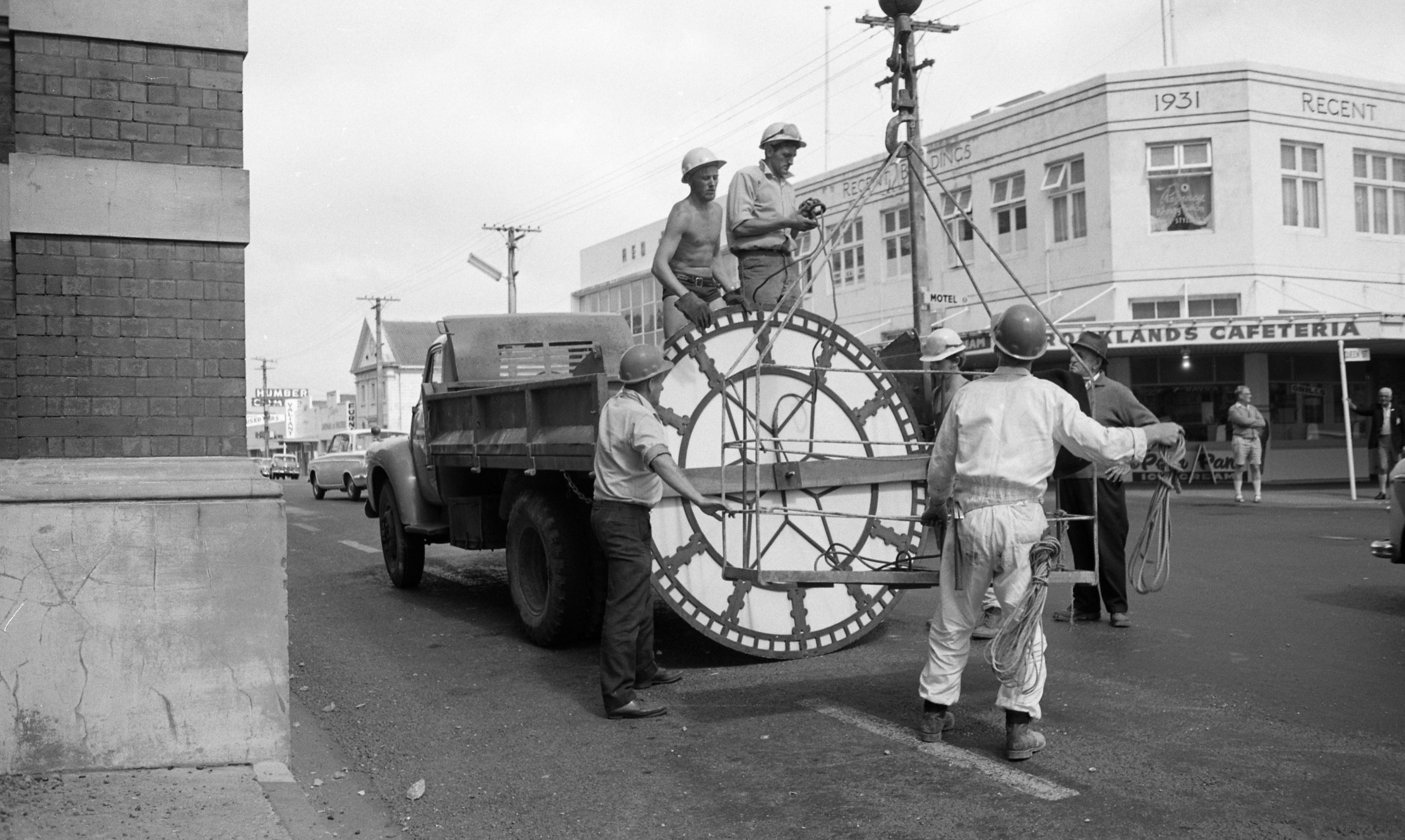 Removal of the clock faces from the clock tower before demolition (1 February 1969). Caleb Wyatt. Collection of Puke Ariki, New Plymouth (PHO2011-2044).