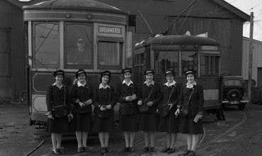 Female tram conductors outside the New Plymouth depot in Fitzroy - Betty Byers is standing on the far right (15 April 1945). Swainson's Studios. Collection of Puke Ariki (SW1945.1579).