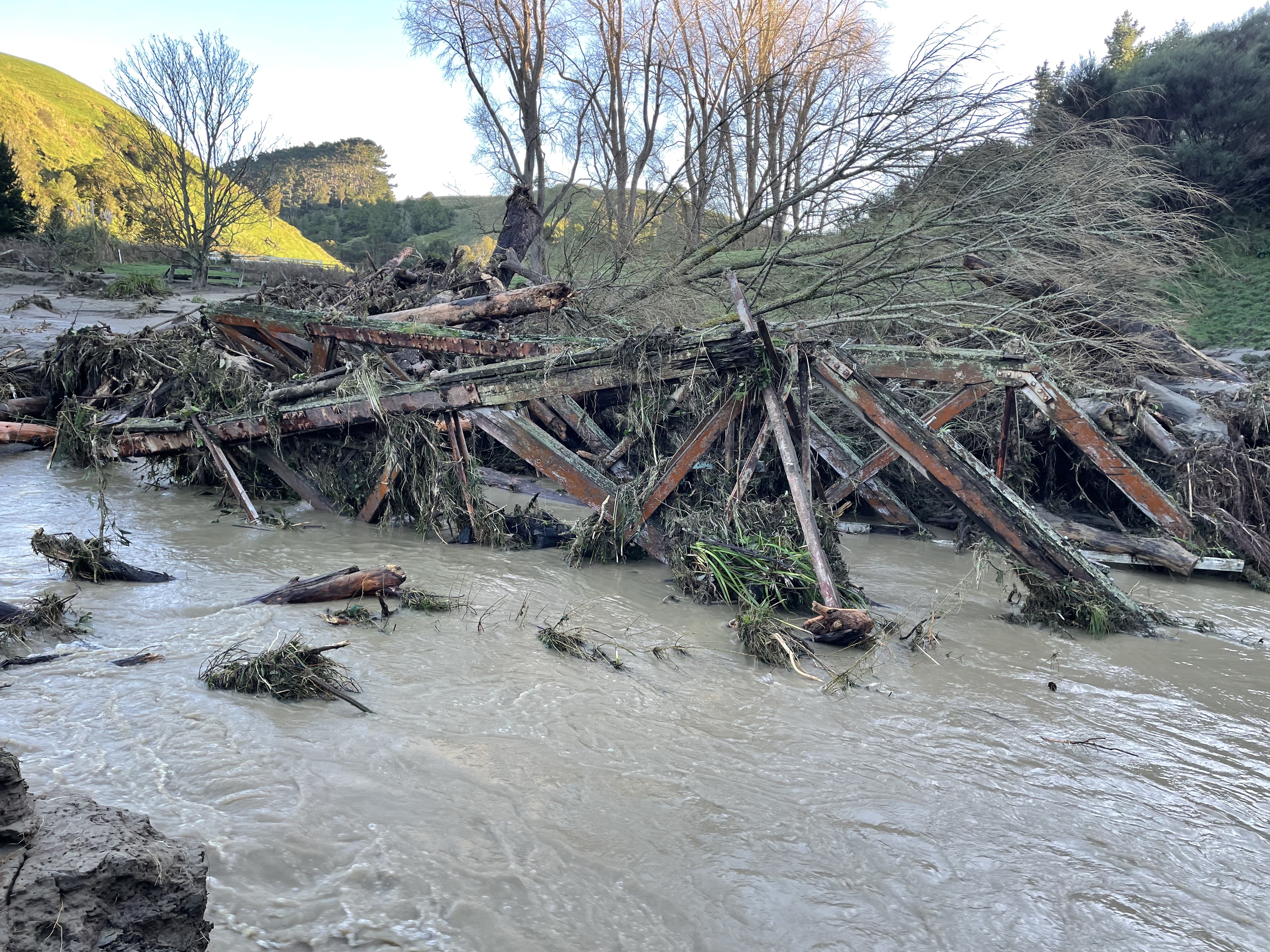 Remains of Mangemange Stream Bridge after floodwaters swept the structure away (5 July 2025). Andrew Edgcombe. Heritage Sites and features image collection.