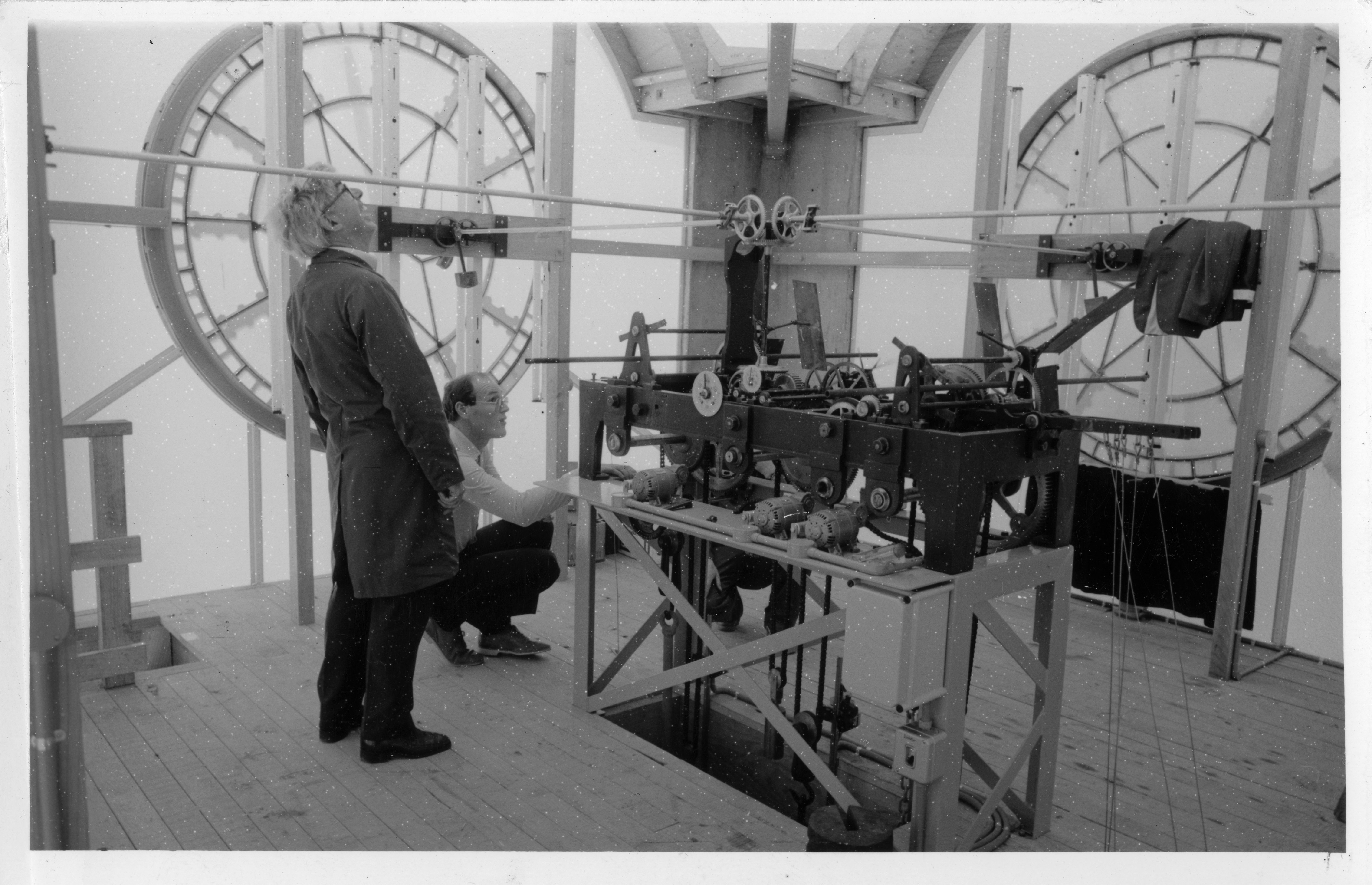 Horologist Henry Rodgers inside the new clock tower with Alan Reed of Boon, Goldsmith & Co. (10 October 1985). Caleb Wyatt. Collection of Puke Ariki (PHO2010-0403).